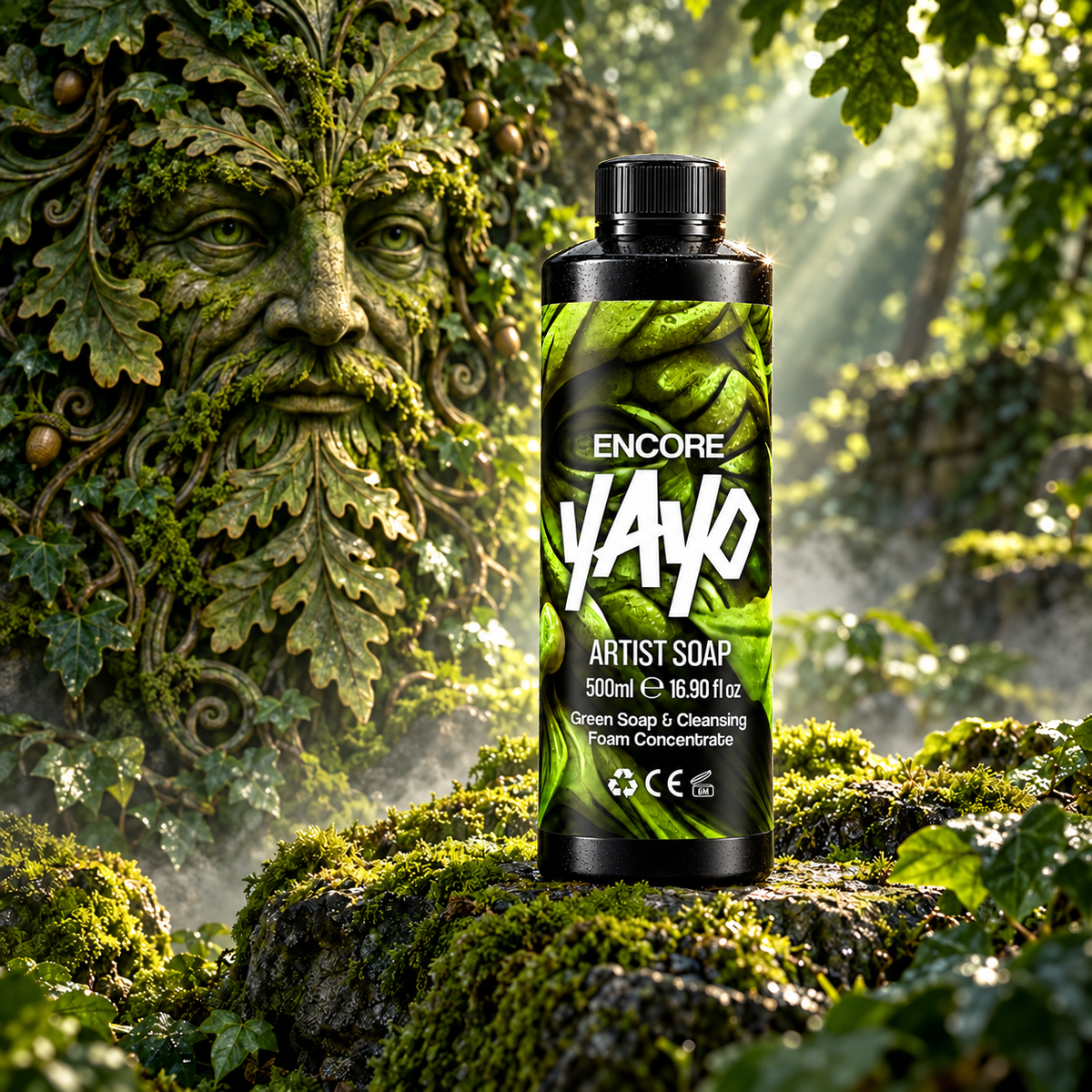 A bottle of Encore YAYO Artist Soap stands on a mossy log in a forest setting with a large stone green man face sculpture in the background