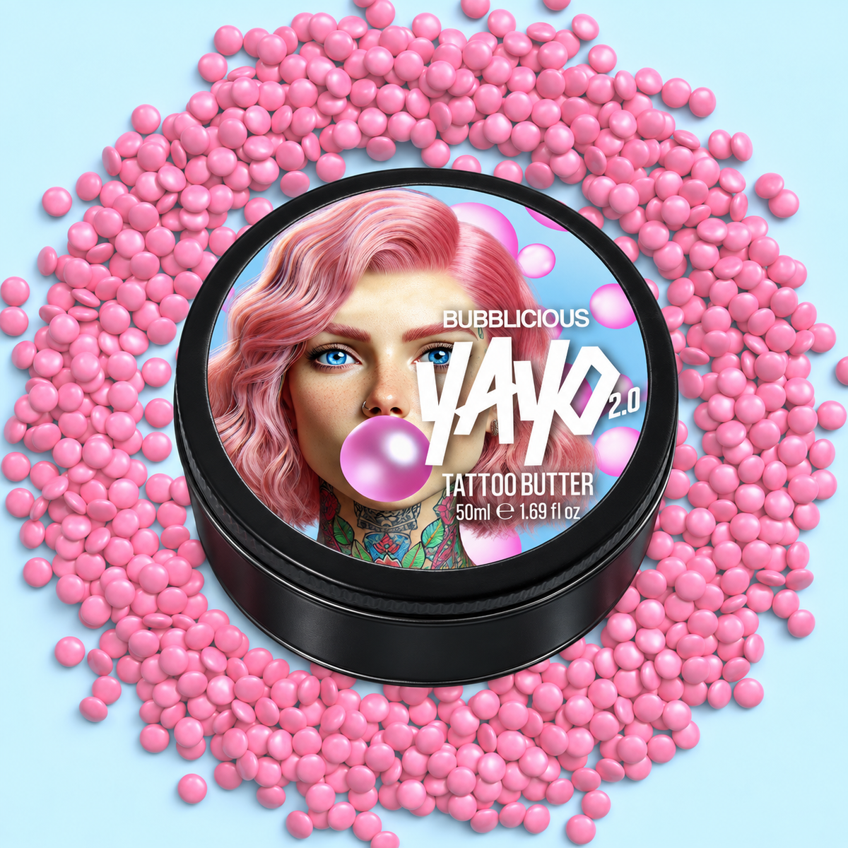 A round black tin of Bubblicious yayo 2.0 Tattoo Butter sits centered on a light blue background, surrounded by a circular arrangement of pink bubblegum-like beads.